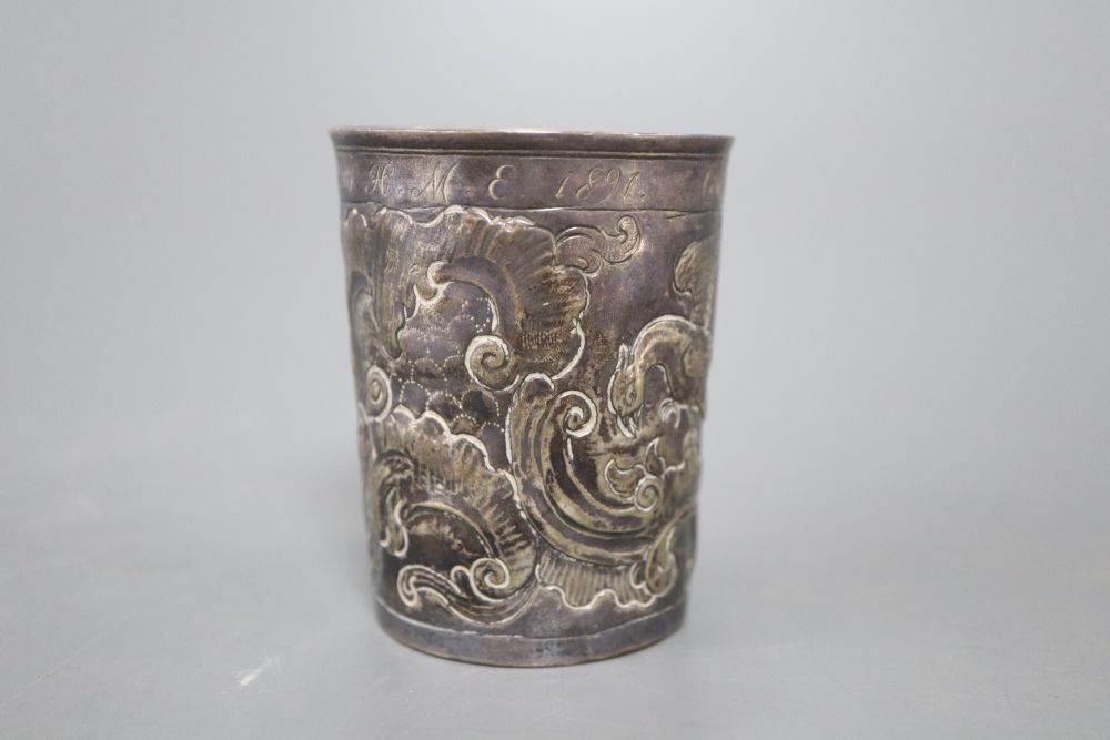 An 18th century Russian embossed white metal beaker, dated 1776, with later inscription, 75mm, 71.9 grams.